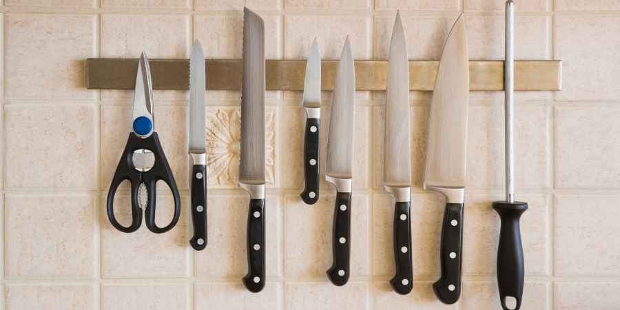 Knives and kitchen utensils on a magnetic strip
