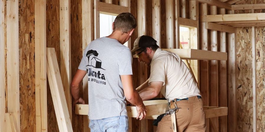 Blog_DakotaEmployeesInstallingShedShelves_900x450