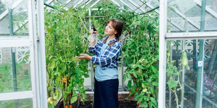 Blog_GirlTendingToPlantsInAGreenhouse_900x450