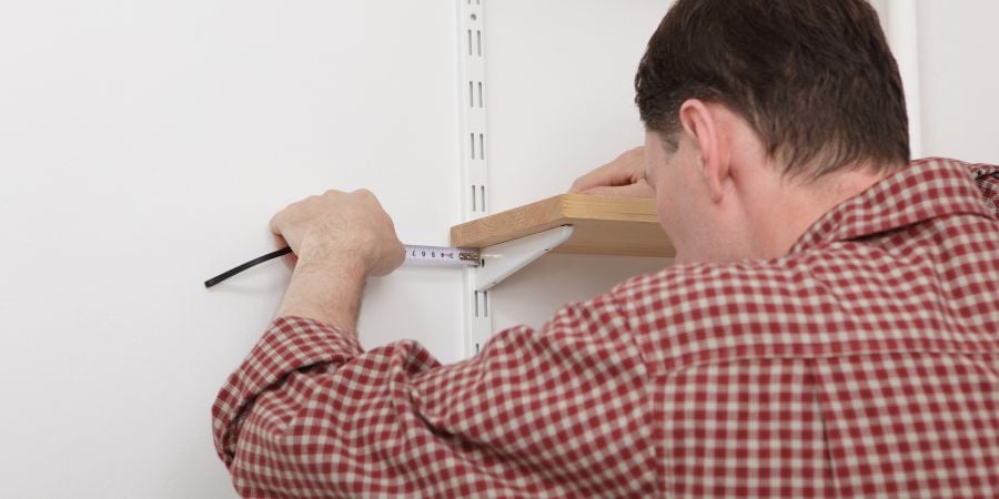 Blog_Man Installing Shelves_900x450