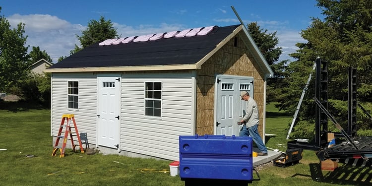 Phase 3—vinyl siding being added and door being hung