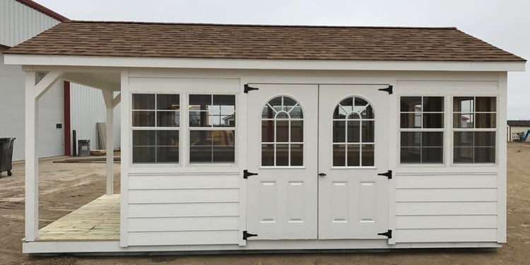 Ranch shed with a porch, many additional windows and several built-in shelves—perfect for gardening and starter plants