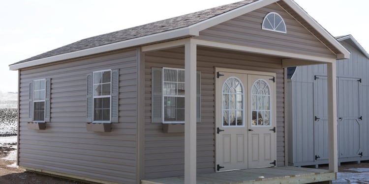 Ranch shed with a porch and double fiberglass door with arched 11 lite window