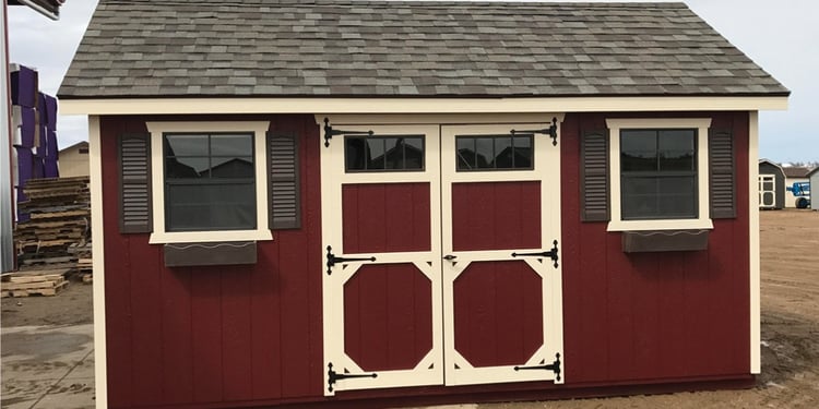 Ranch shed with a trim kit, decorative hinges, shutters, flower boxes and a double door featuring transom 4 lite windows