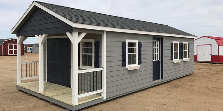 Ranch porch shed with 4’ railings and 32” balusters, fiberglass doors, shutters, and window boxes